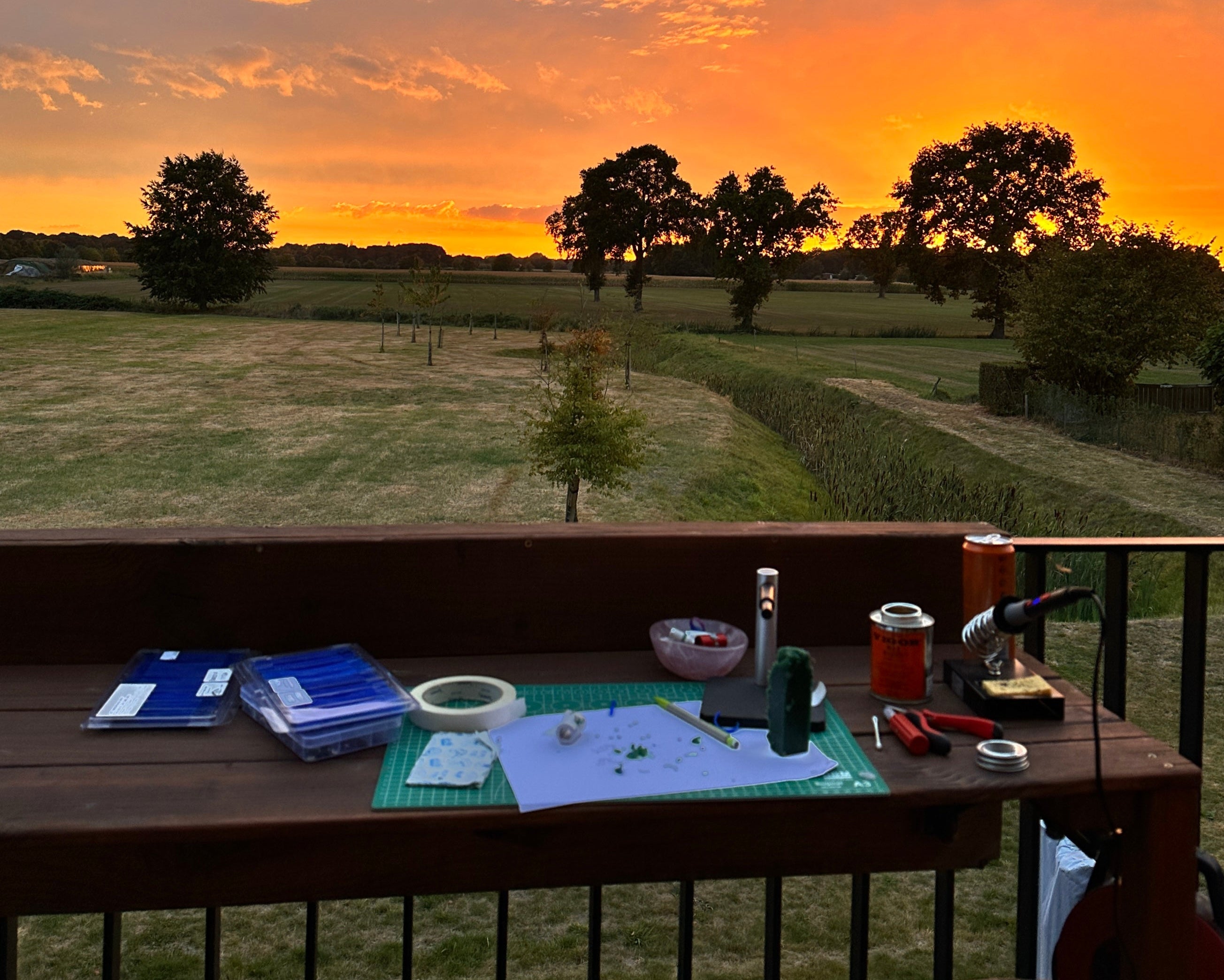 Sunset over a field with a table in the foreground